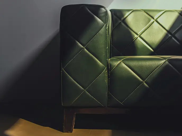 Modern dark green leather sofa with chrome frame - leather repair and restoration service NYC