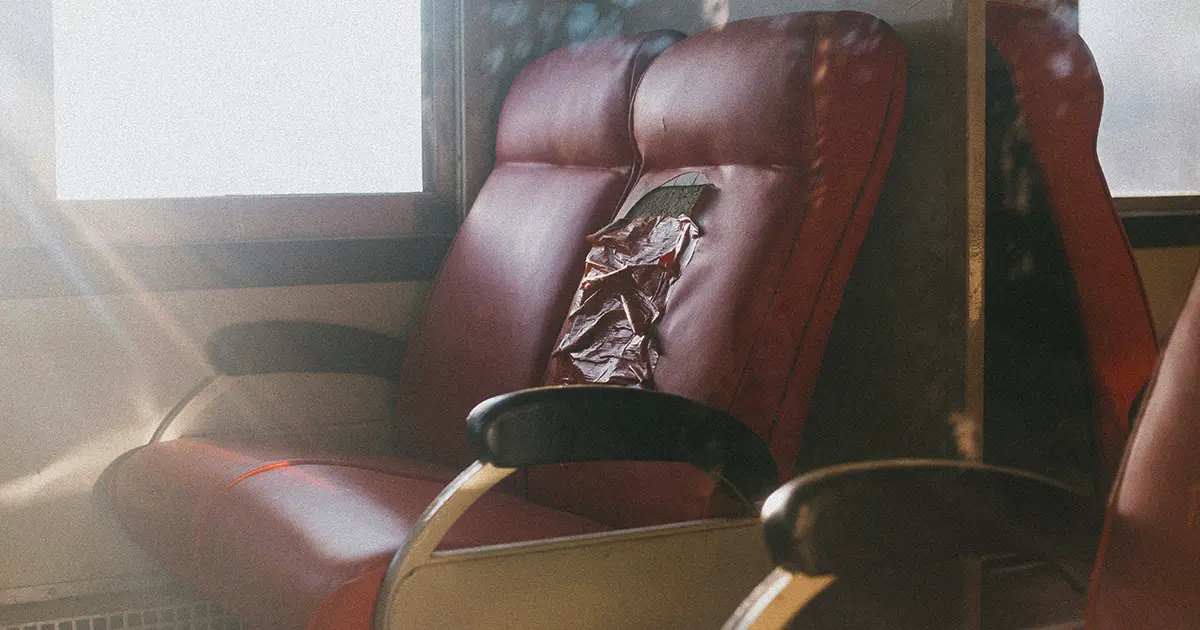 orn cracked leather seat with visible damage